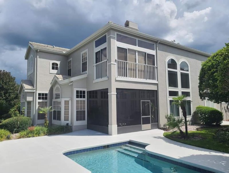 Two-story home with pool and screened lanai after an exterior repaint