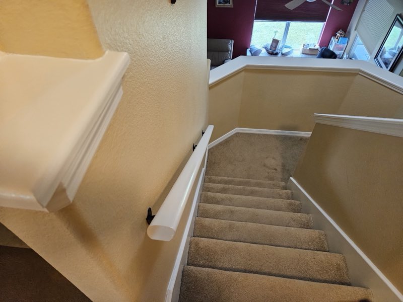 Interior stairwell and handrail repainted in warm tones